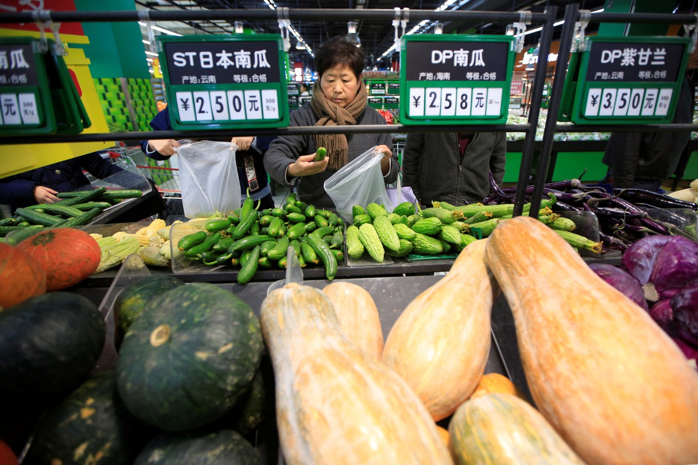 Consumers choose vegetables at a supermarket in Shanghai