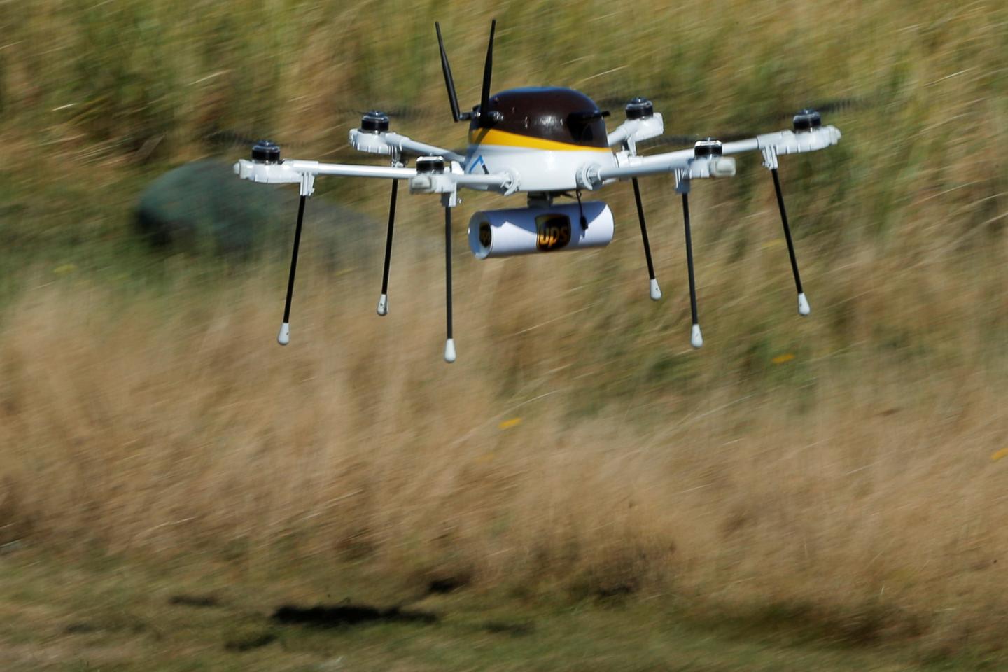 A drone, made by CyPhy Works, carries a UPS package on Children's Island off the coast of Beverly