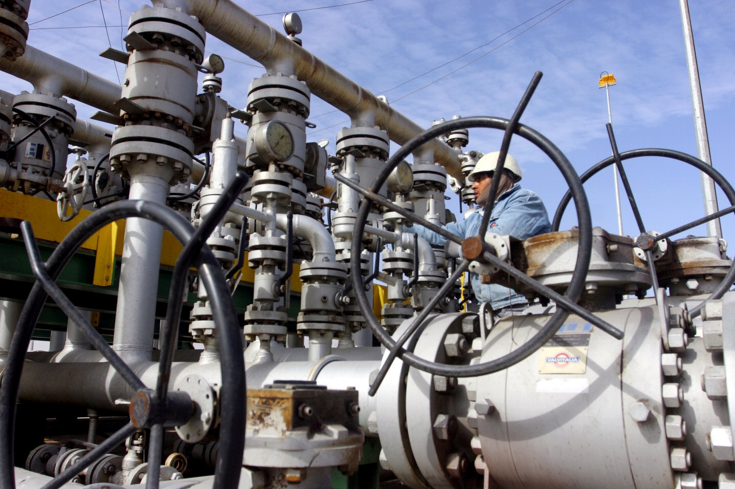 A worker checks the valves at Al-Sheiba oil refinery in the southern Iraq city of Basra