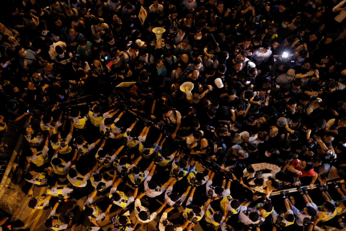 Police stop demonstrators as they protest in Hong Kong