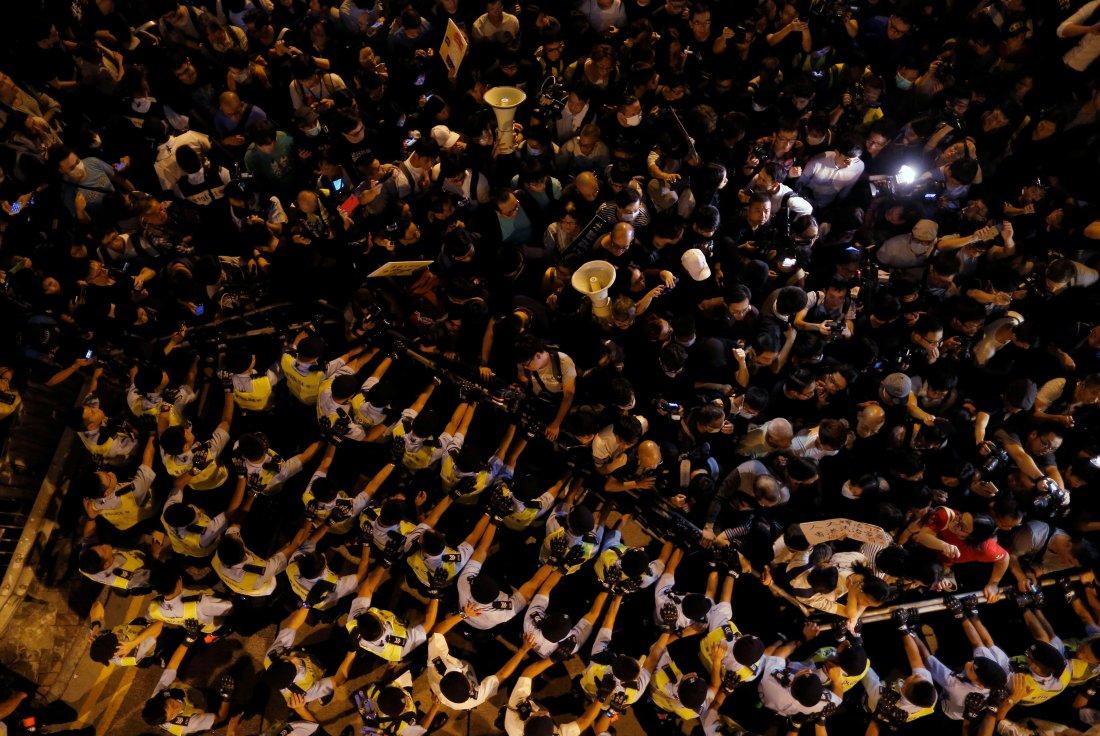 Police stop demonstrators as they protest in Hong Kong