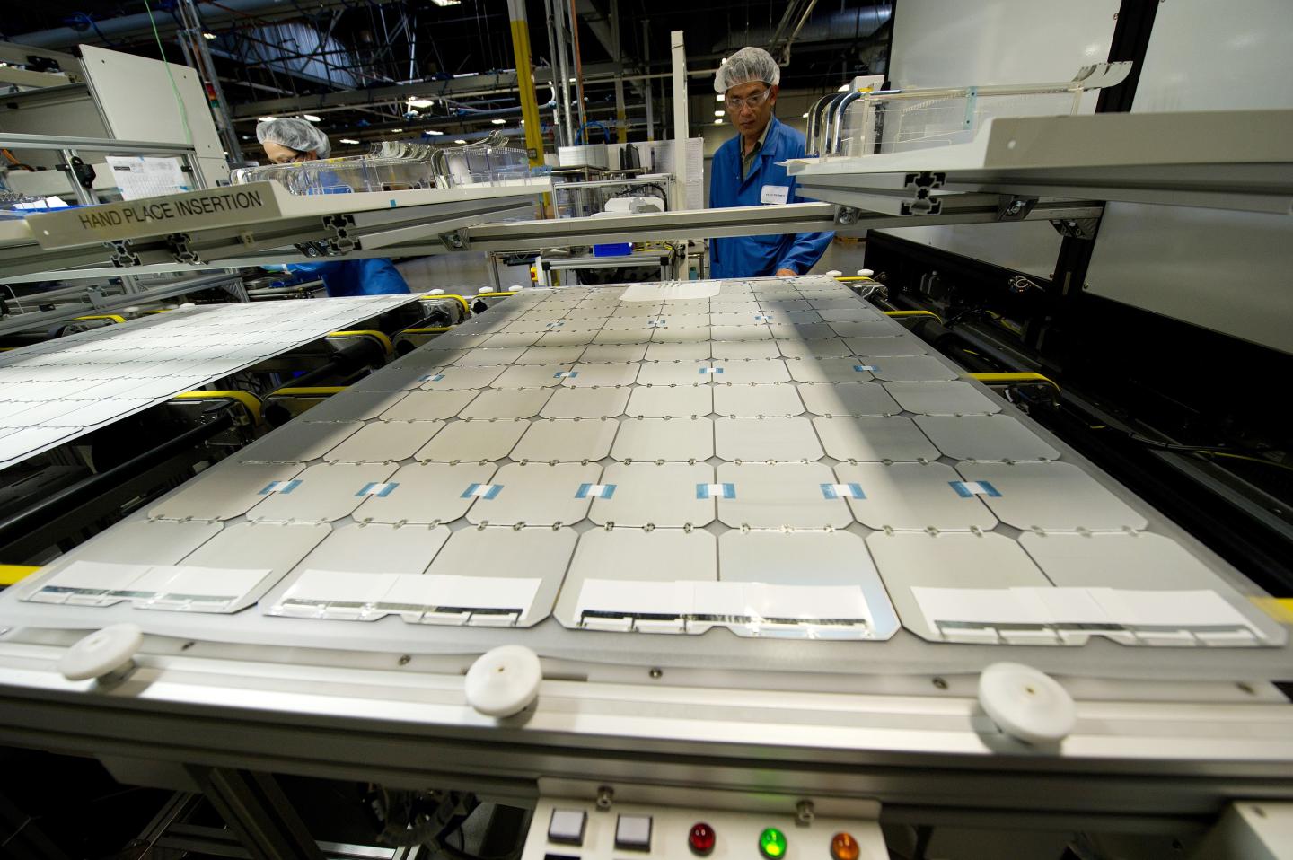 An employee of SunPower looks over solar panels at the SunPower module manufacturing plant at Flextronics in Milpitas, Calif.