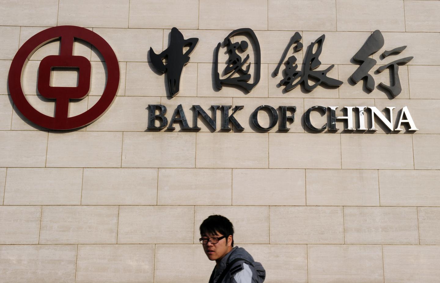 A man walks past the Bank of China headq
