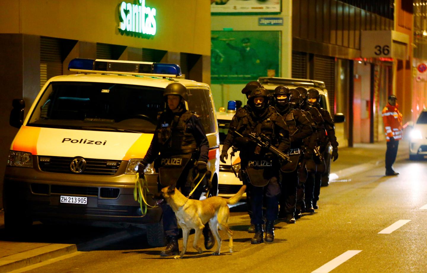 Police stand outside an Islamic center in central Zurich