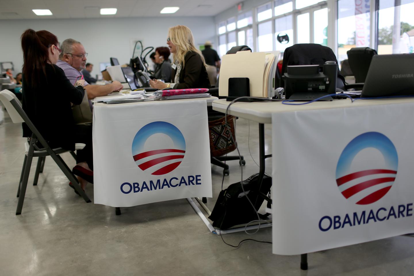 Aymara Marchante (L) and Wiktor Garcia sit with Maria Elena Santa Coloma, as they sign up for the Affordable Care Act, also known as Obamacare, before the February 15th deadline on February 5, 2015 in Miami, Florida.