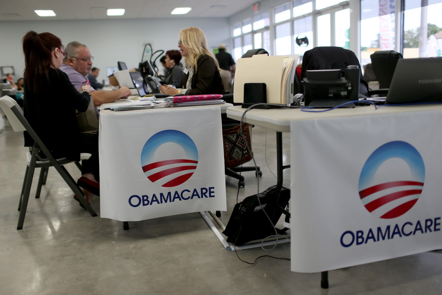 Aymara Marchante (L) and Wiktor Garcia sit with Maria Elena Santa Coloma, as they sign up for the Affordable Care Act, also known as Obamacare, before the February 15th deadline on February 5, 2015 in Miami, Florida.