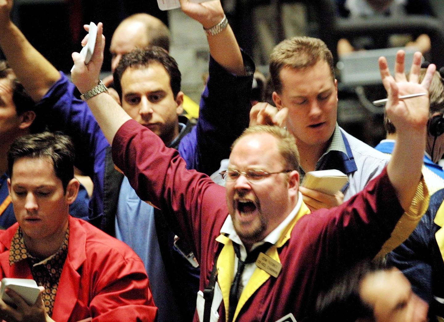 A trader signals a trade in the Dow Jones Industri