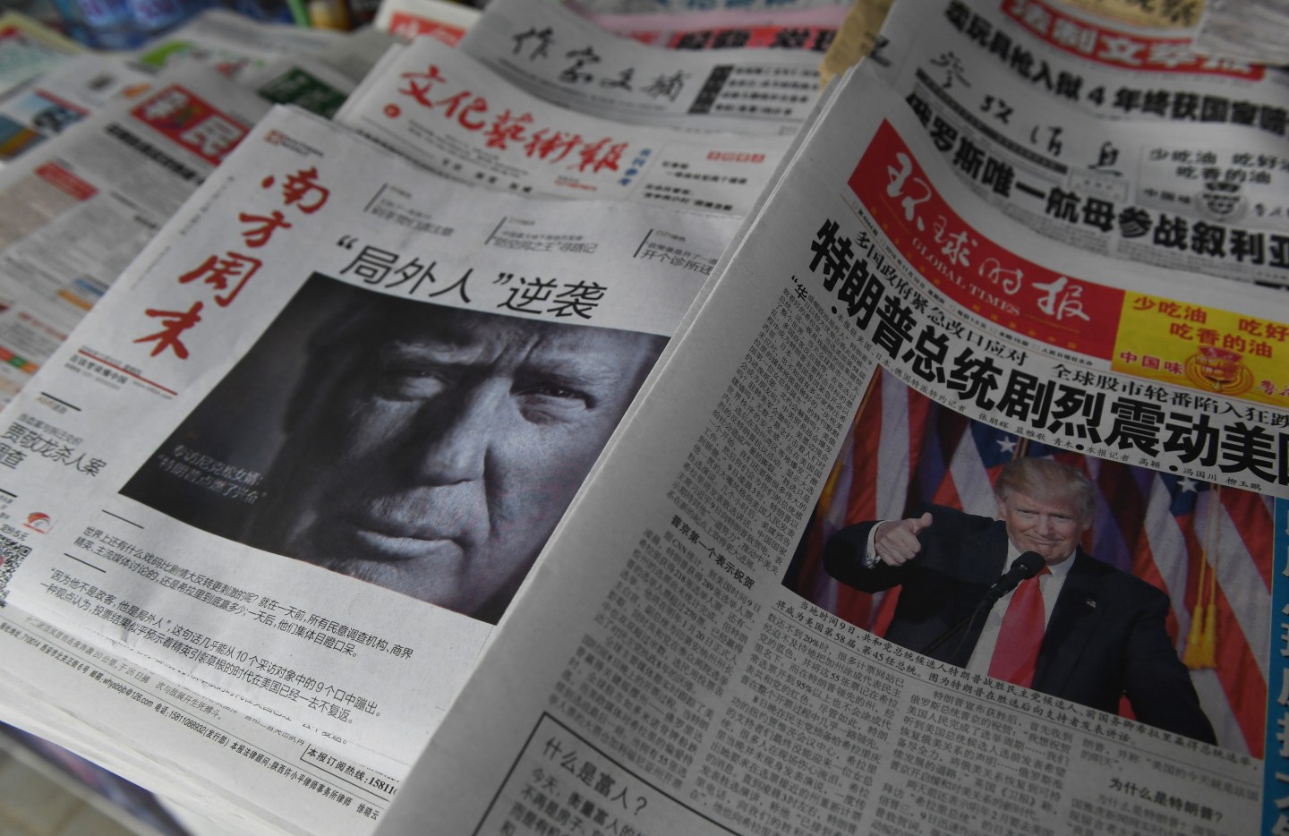 Chinese newspapers feature front page photos of US President-elect Donald Trump, at a news stand in Beijing on November 10, 2016.