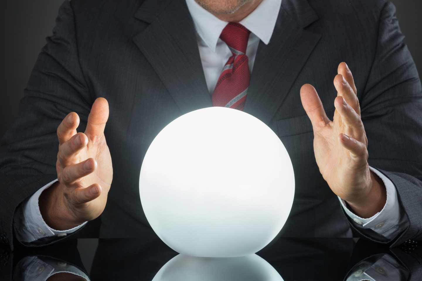 Close-up Of Businessman Hand On Crystal Ball