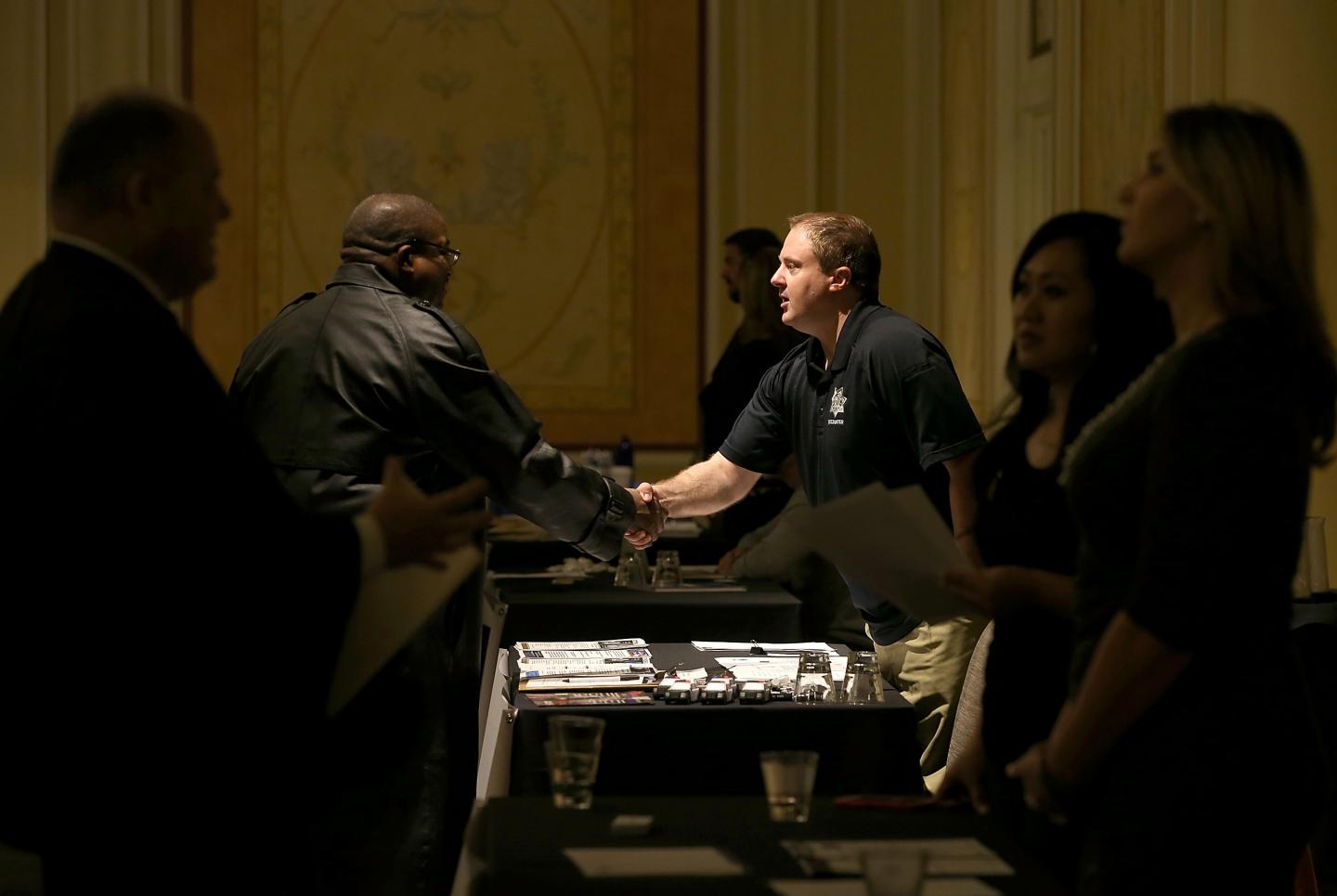Job Seekers Look For Employment At Career Fair