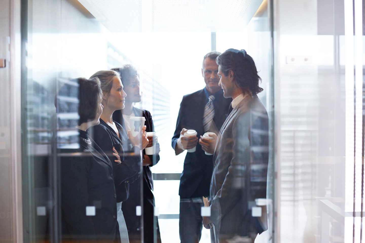 Business people standing together in elevator