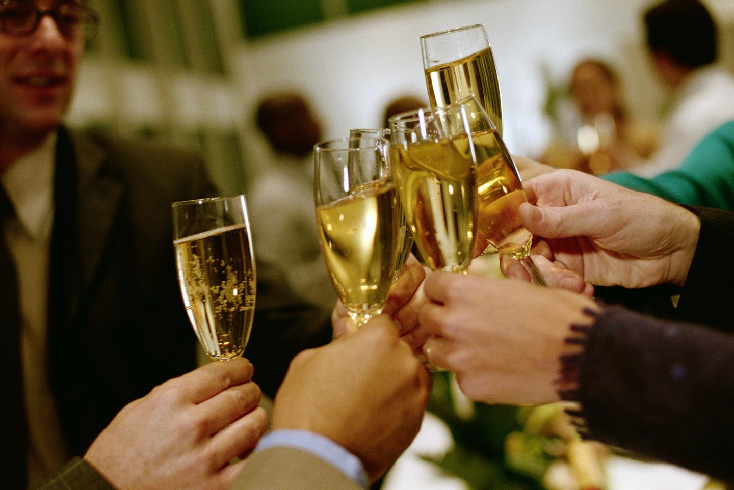 PEOPLE TOASTING WITH CHAMPAGNE GLASSES