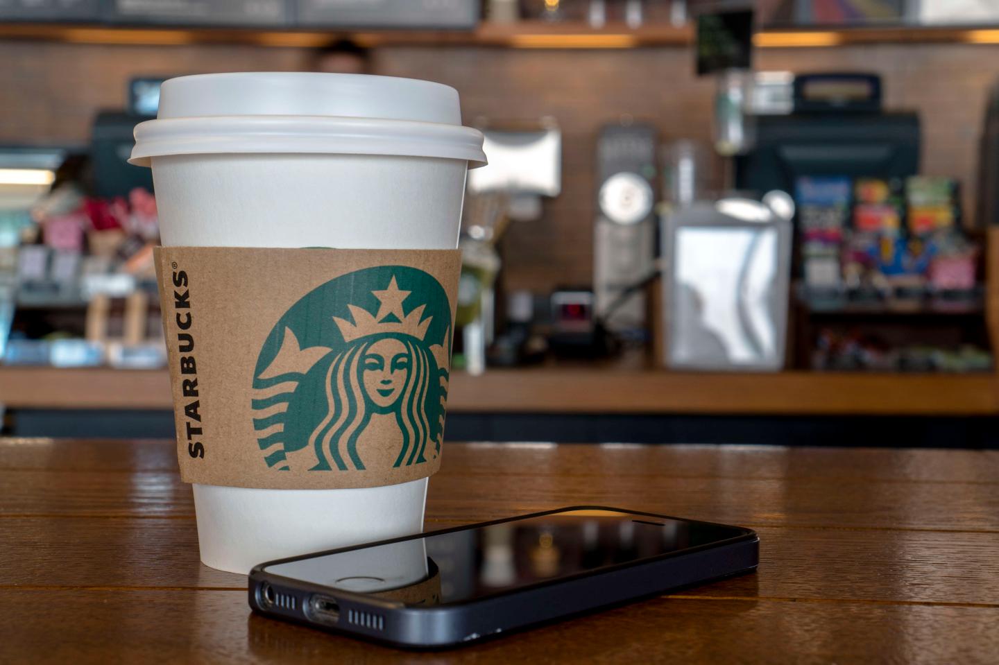 Coffee cup on table in a Starbucks shop.  During the third