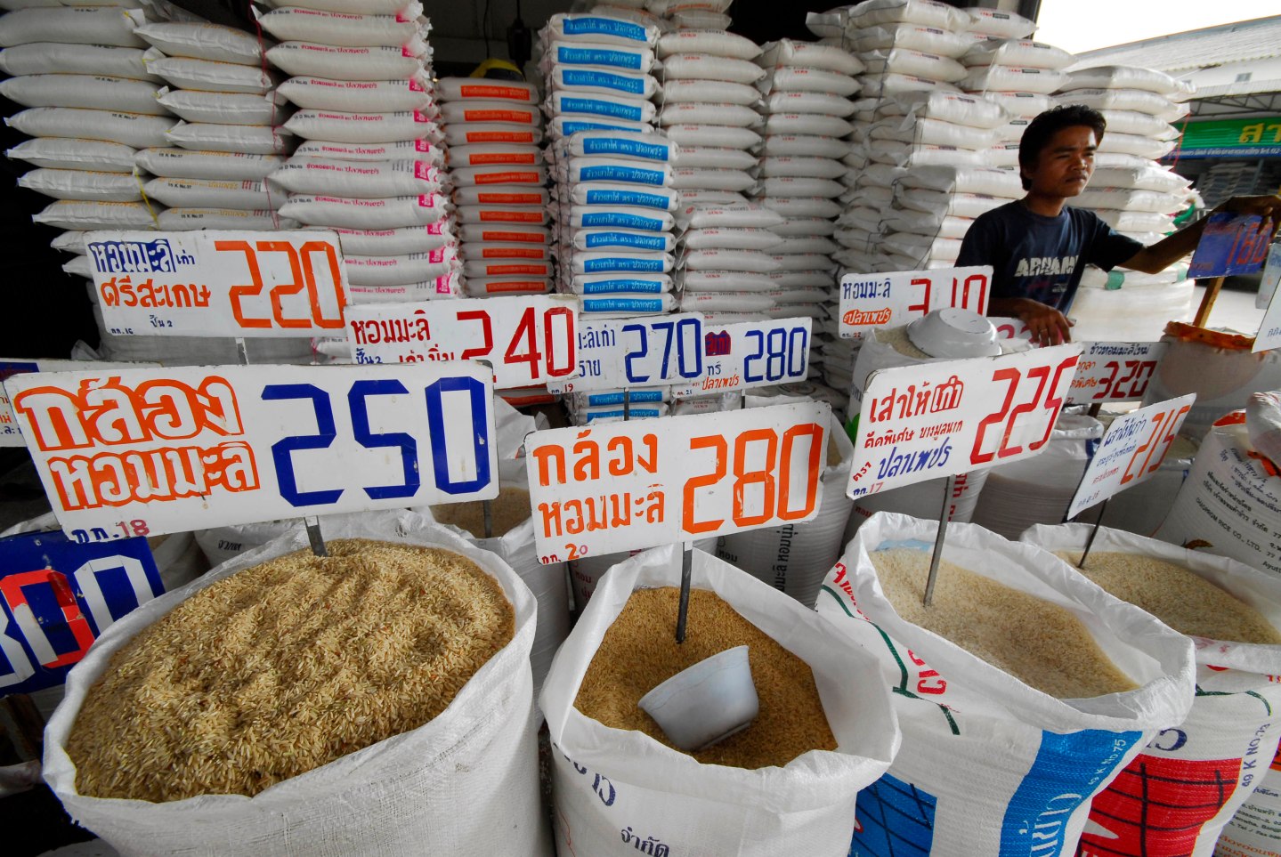 A vendor sells rice at at a shop in a produce market in Nawa