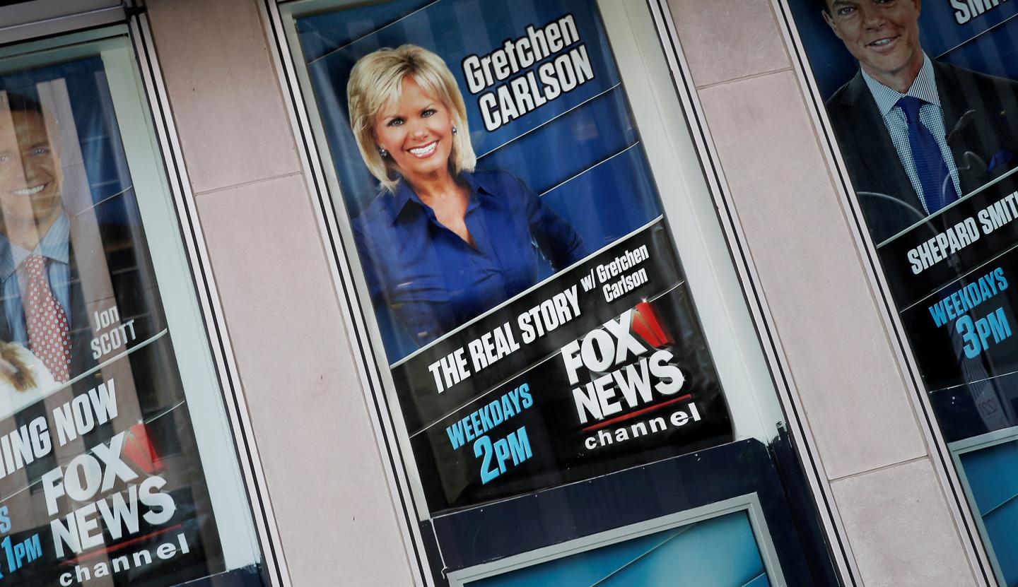 Posters of Fox News personalities including Gretchen Carlson are seen at the News Corporation headquarters building in New York