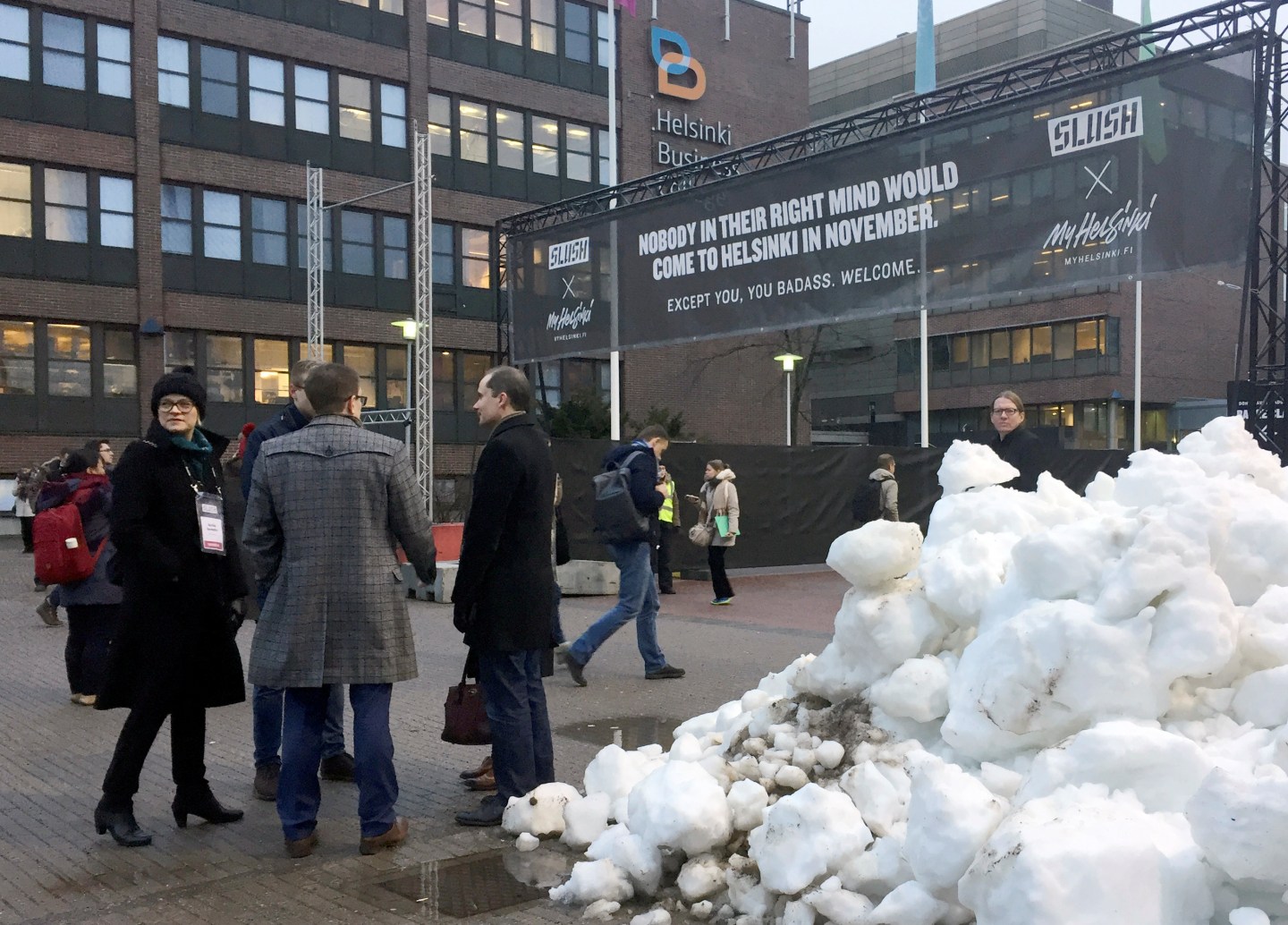 People gather near the entrance to the venue of Slush, one of Europe's biggest tech start-up conferences in Helsinki