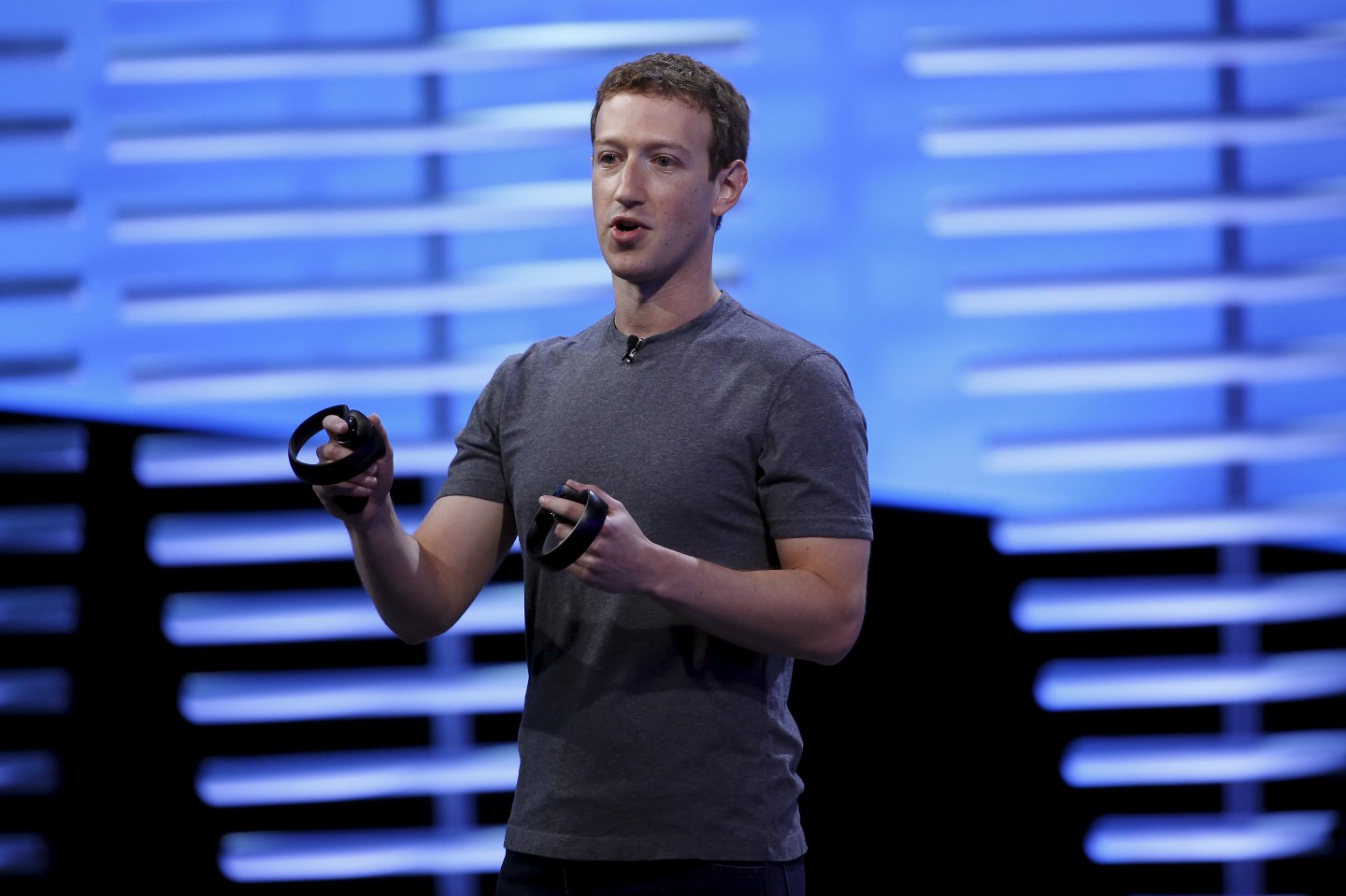 Facebook CEO Mark Zuckerberg holds a pair of the touch controllers for the Oculus Rift virtual reality headsets during the Facebook F8 conference in San Francisco, California