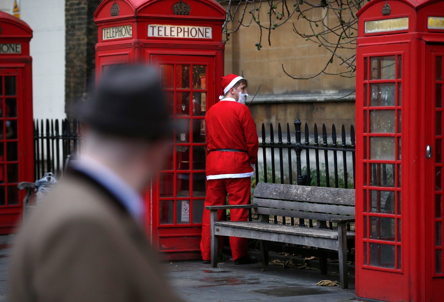 A man dressed as Santa Claus relieves himself during the Santacon event in London