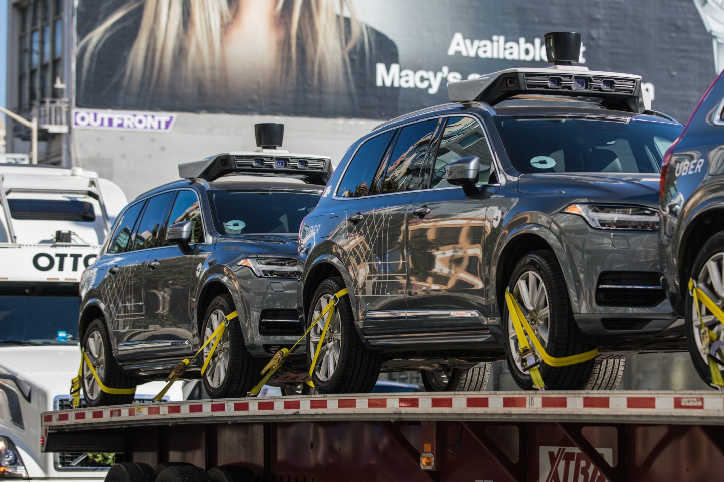 Uber's self-driving Volvo cars being loaded on an Otto truck.