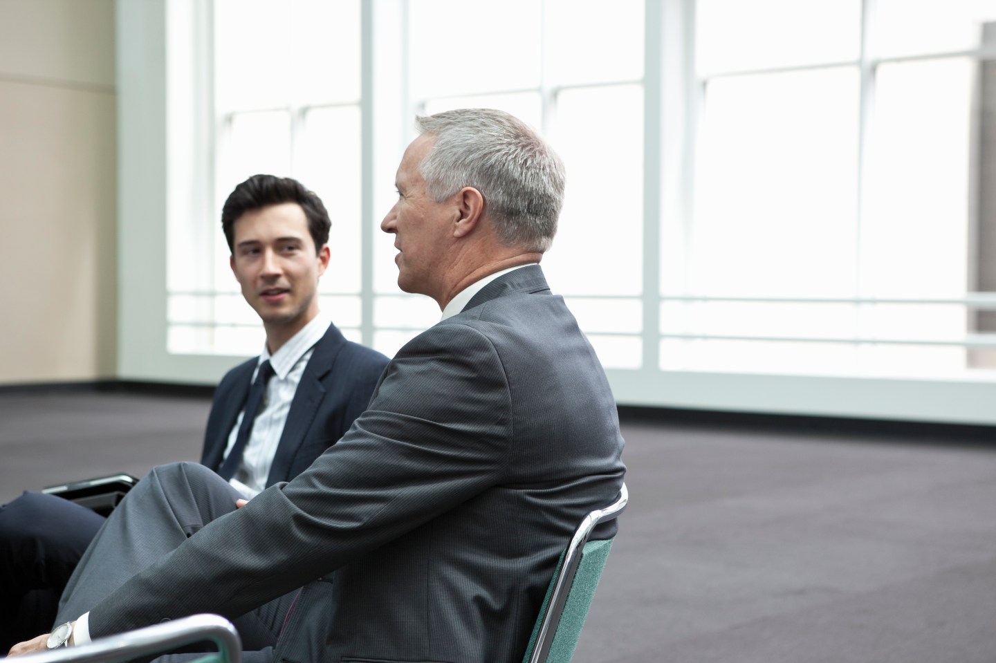 Young business man listening to older business man