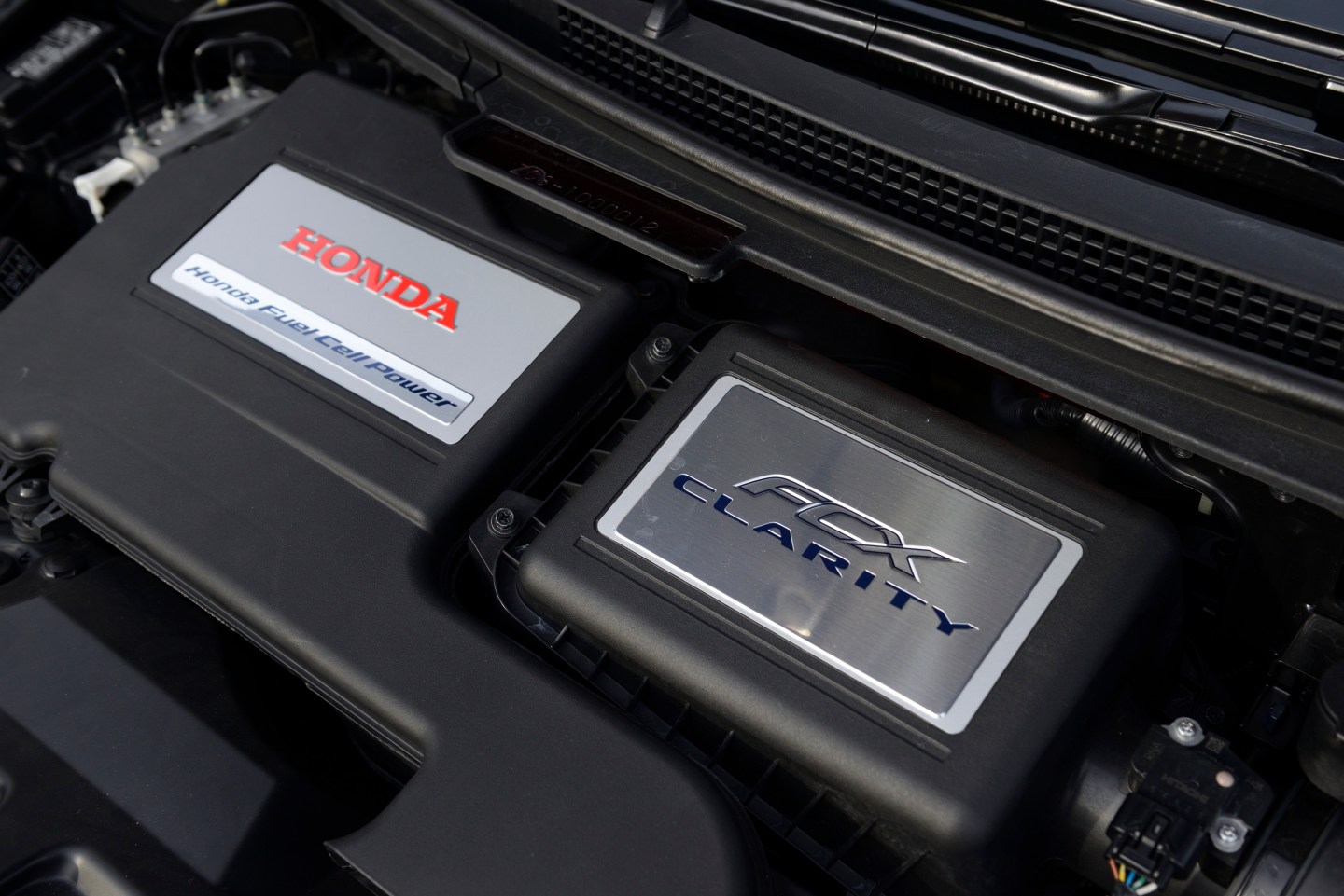 The Honda Motor logo is displayed on a FCX Clarity fuel cell vehicle (FCV) during the unveiling of the company's smart hydrogen fueling station in Japan on Thursday, Sept. 18, 2014.