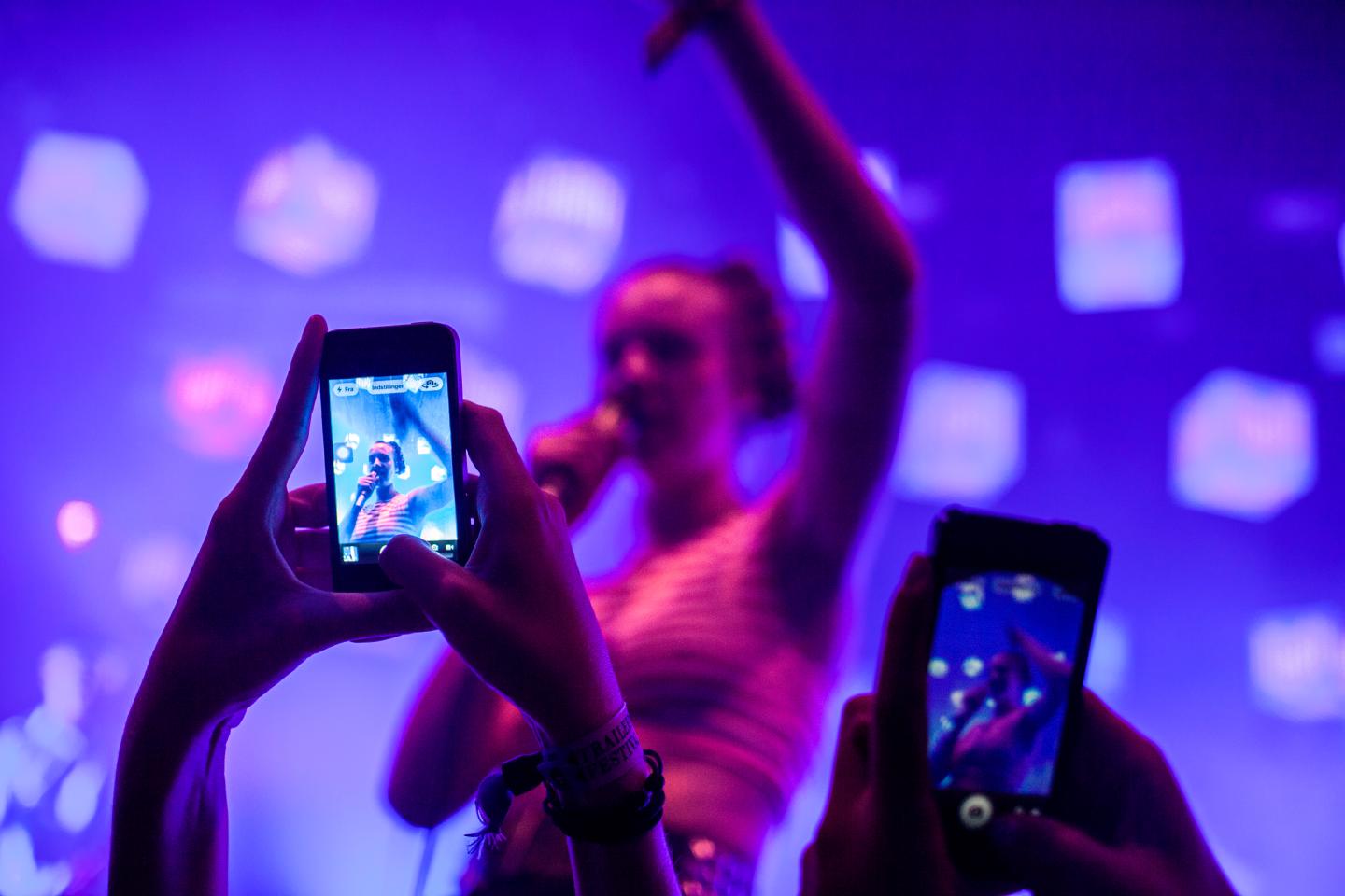 Concert guests take photos with their smart phones at a live concert. Denmark 2013.
