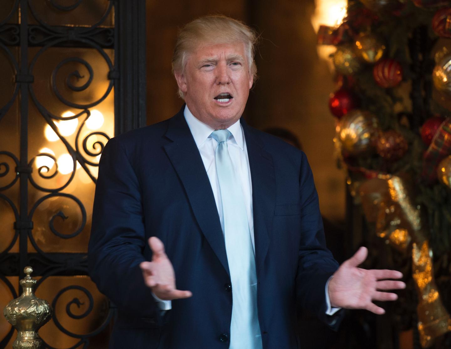 US President-elect Donald Trump answers questions from the media after a day of meetings on December 28, 2016 at Mar-a-Lago in Palm Beach, Florida.