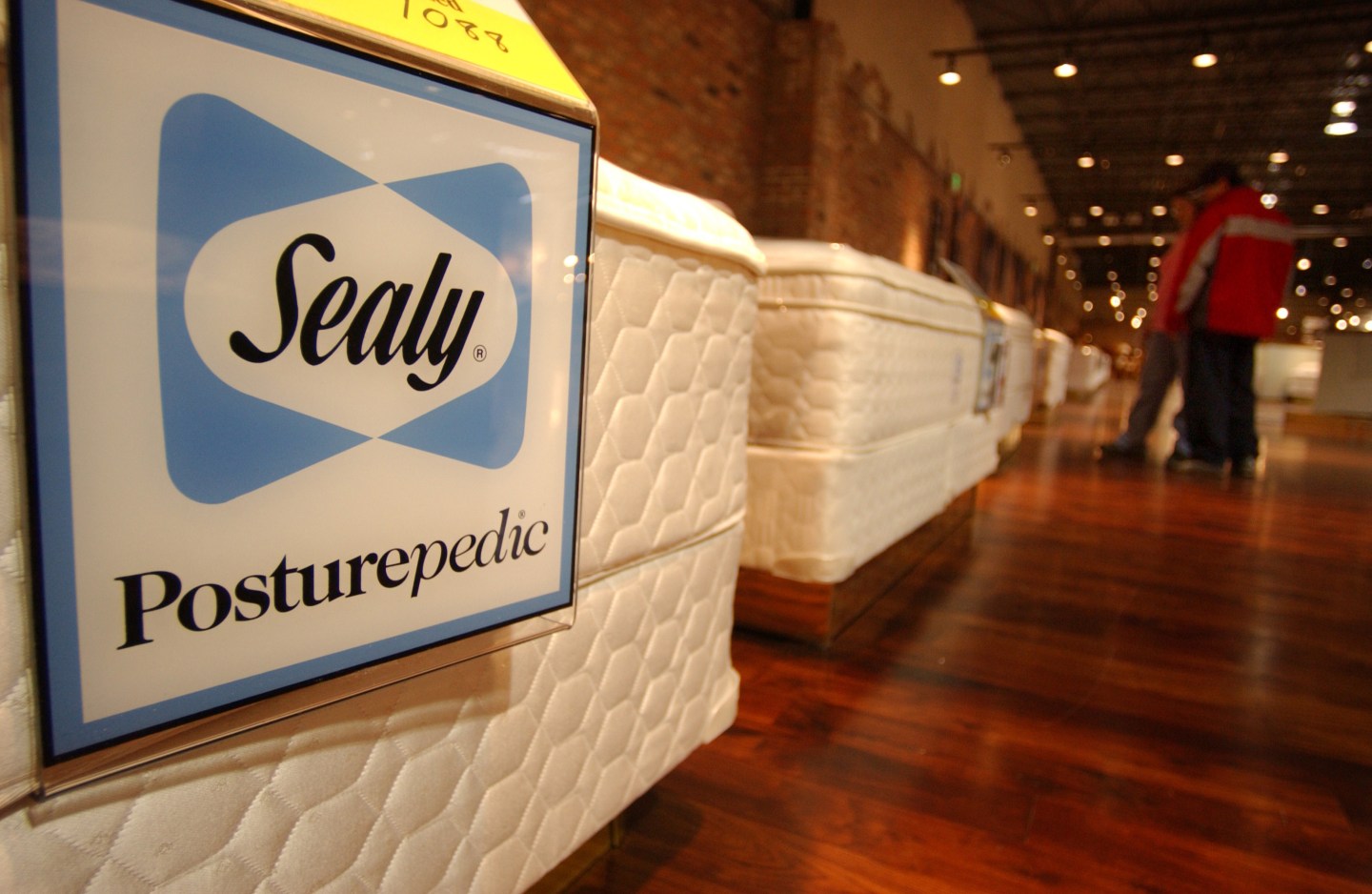 Joel and Elizabeth Perea shop for a bed in the Sealy section