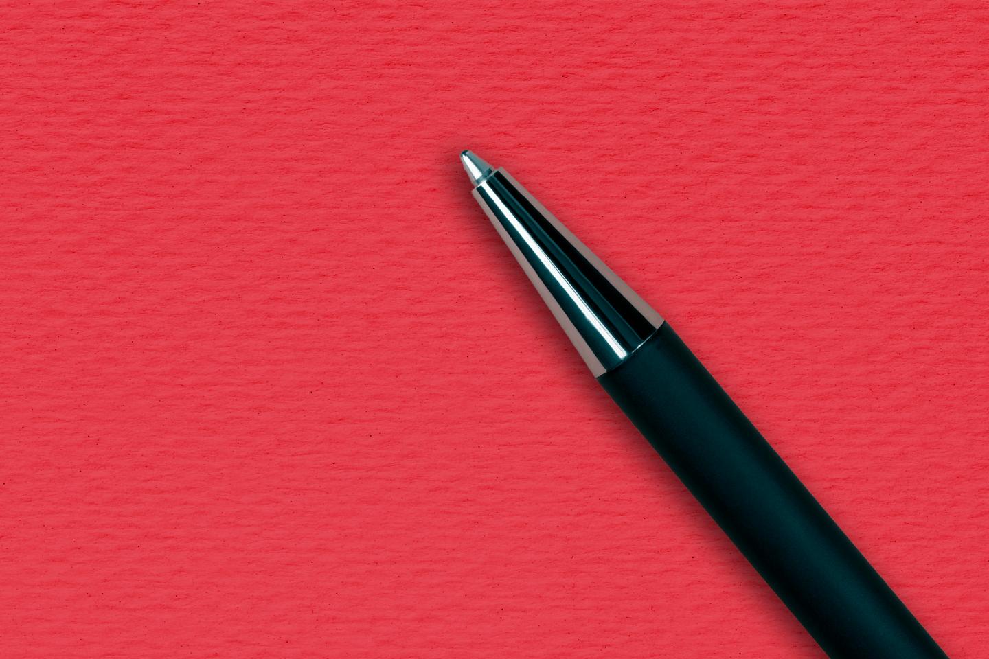 Black ball pen on the red papper background