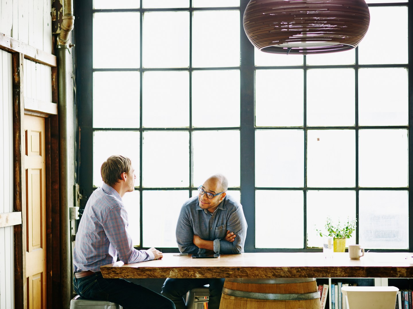 Smiling businessman in discussion with colleague