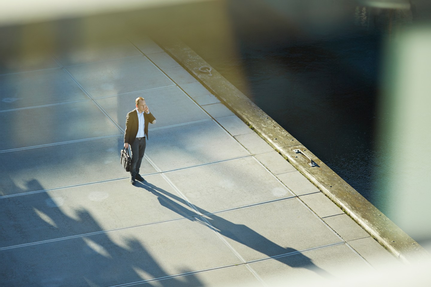 Businessman standing outside with phone