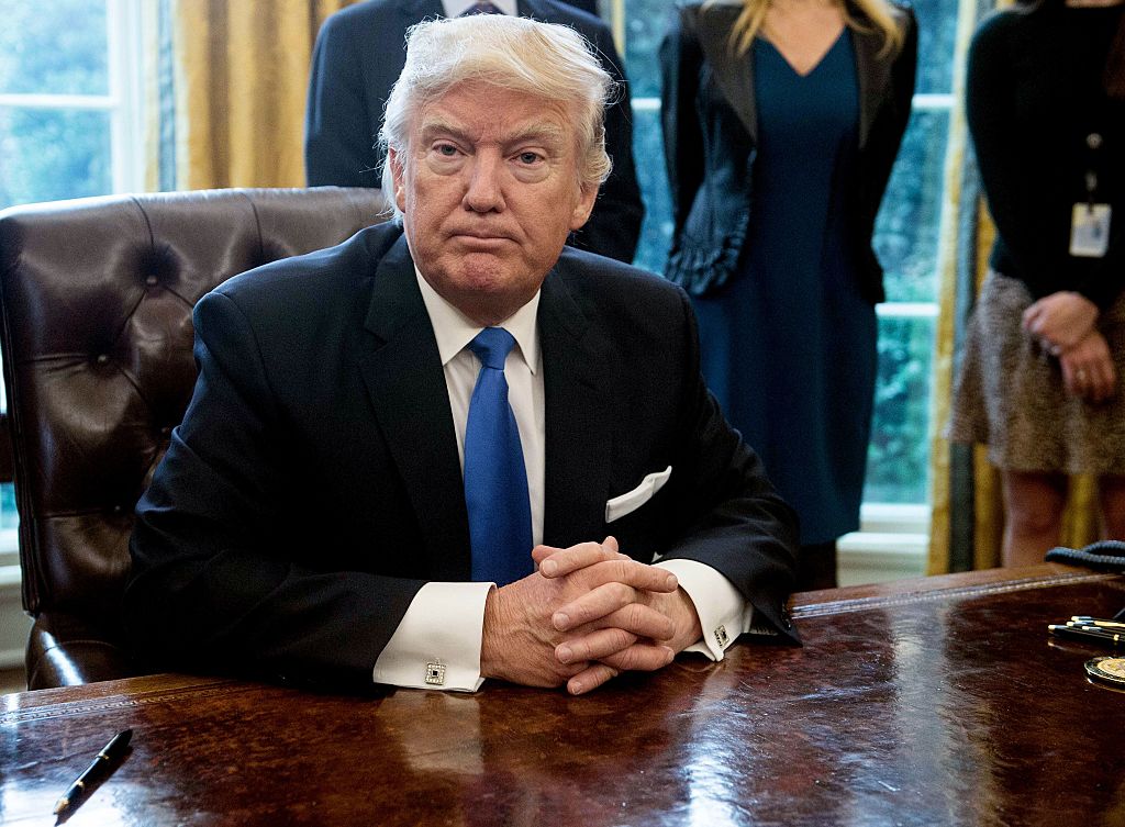 President Donald Trump looks on after signing executive orders in the Oval Office at the White House in Washington, D.C., on Jan. 24, 2017.