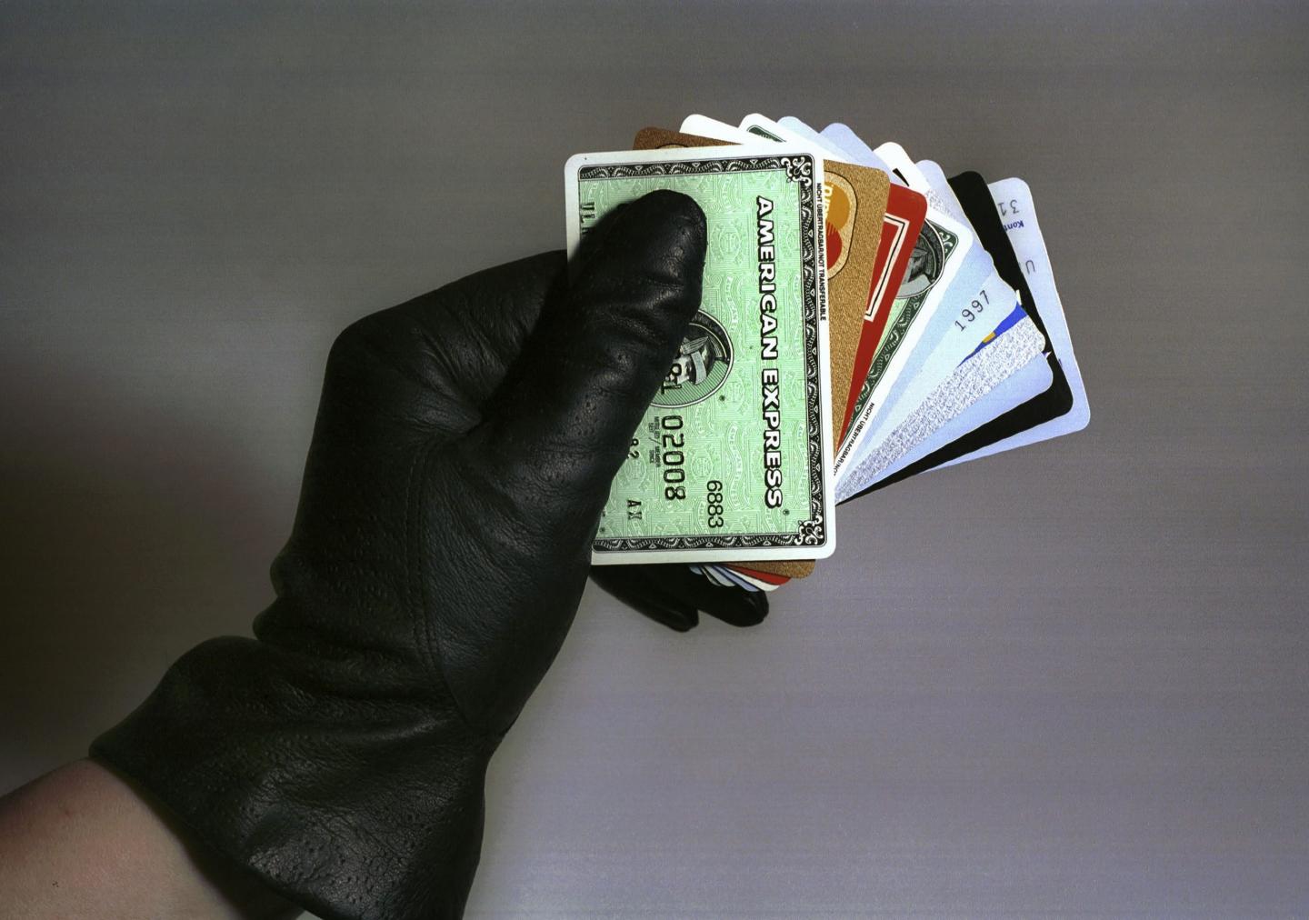 Symbolic Photo to topic's: Crime, Our Picture shows: Hand with glove hold various credit cards.