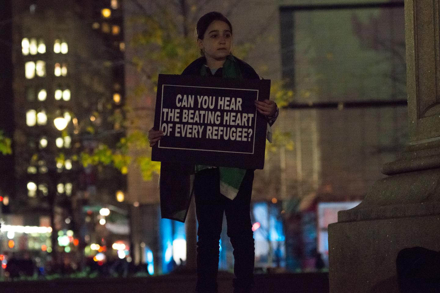 Demonstrators hold aloft signs at the rally against Donald