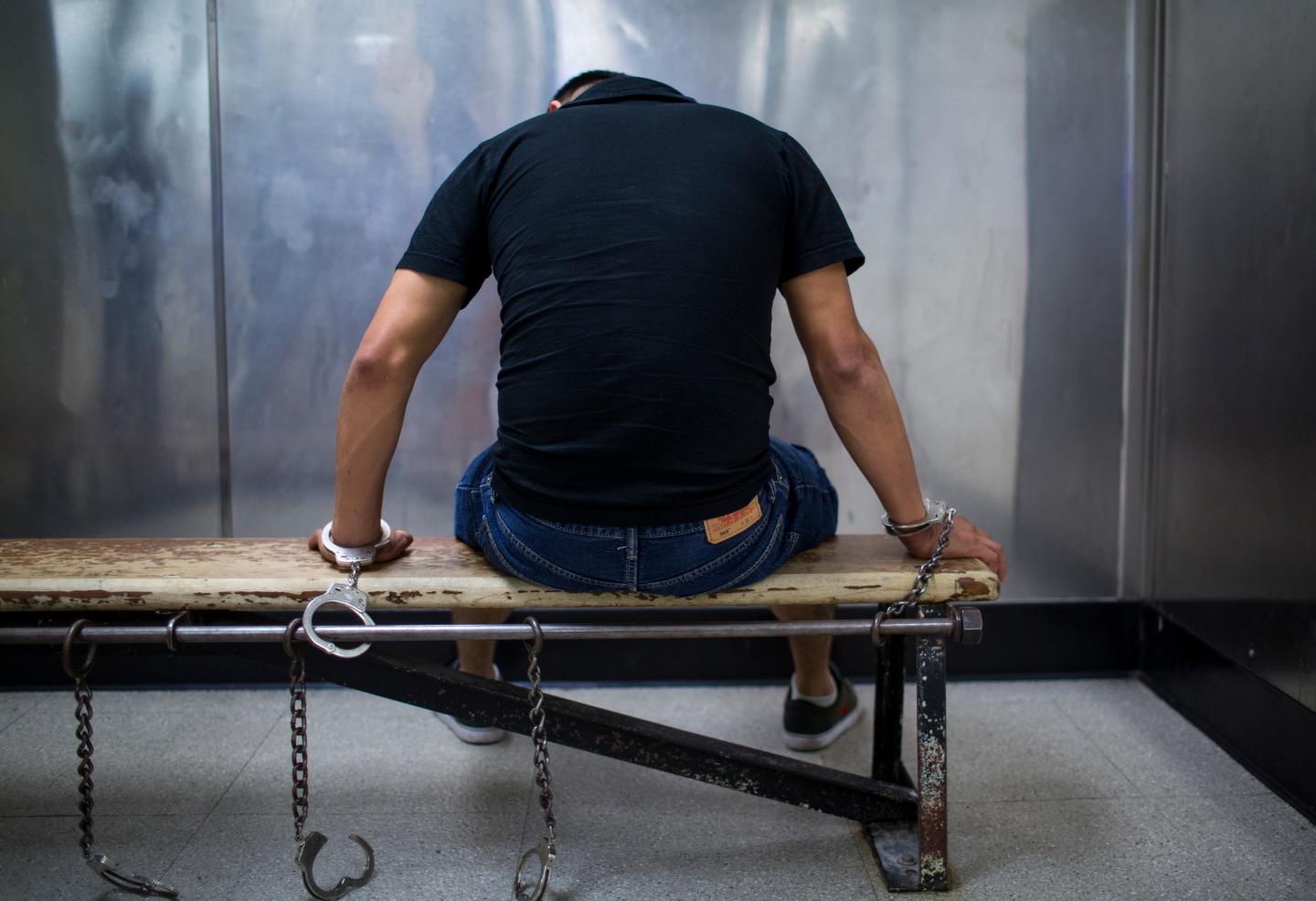 Male Suspect Handcuffed To Bench