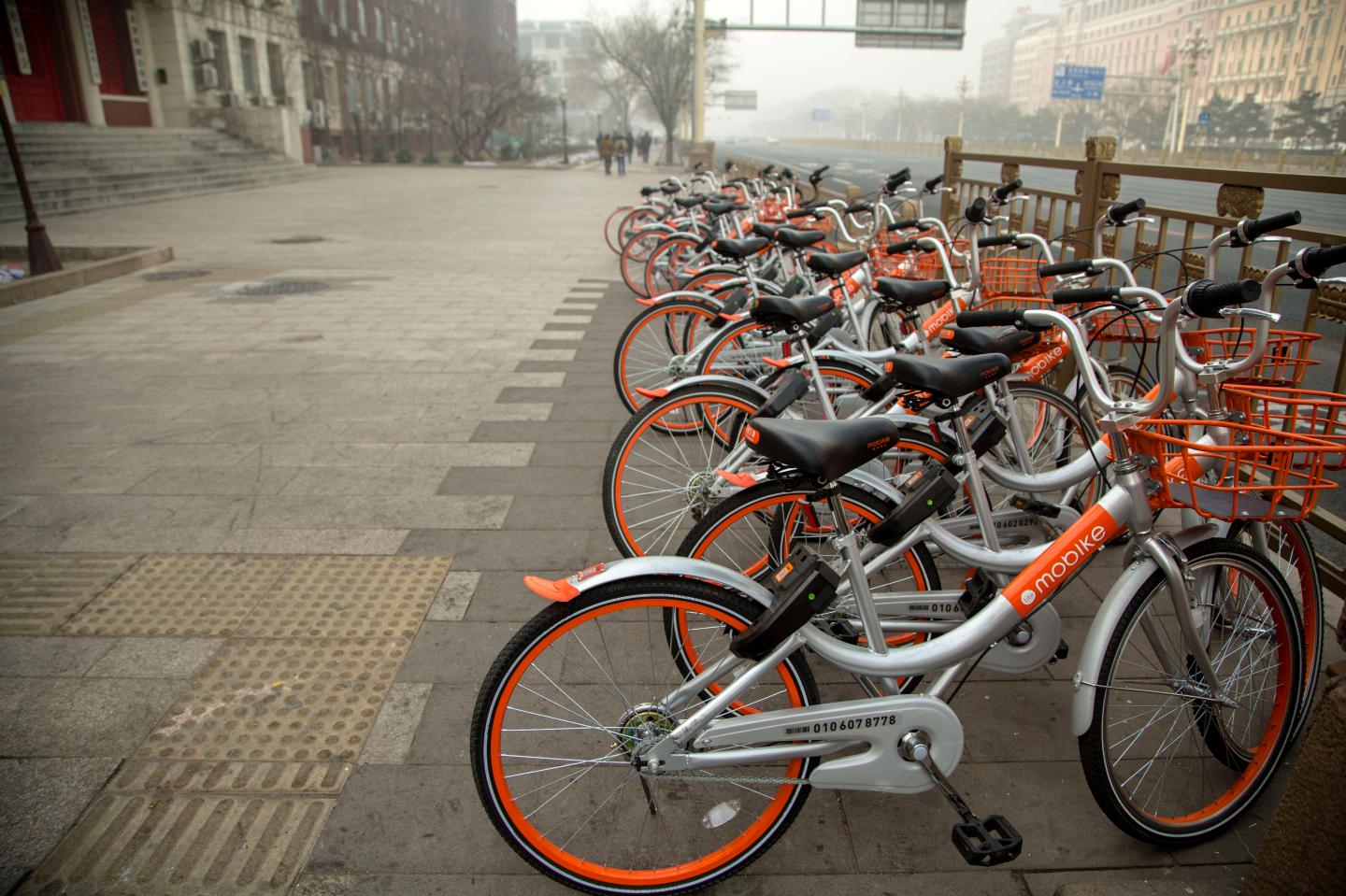 Mobikes bikes lined up on the streets.  Mobike is one of