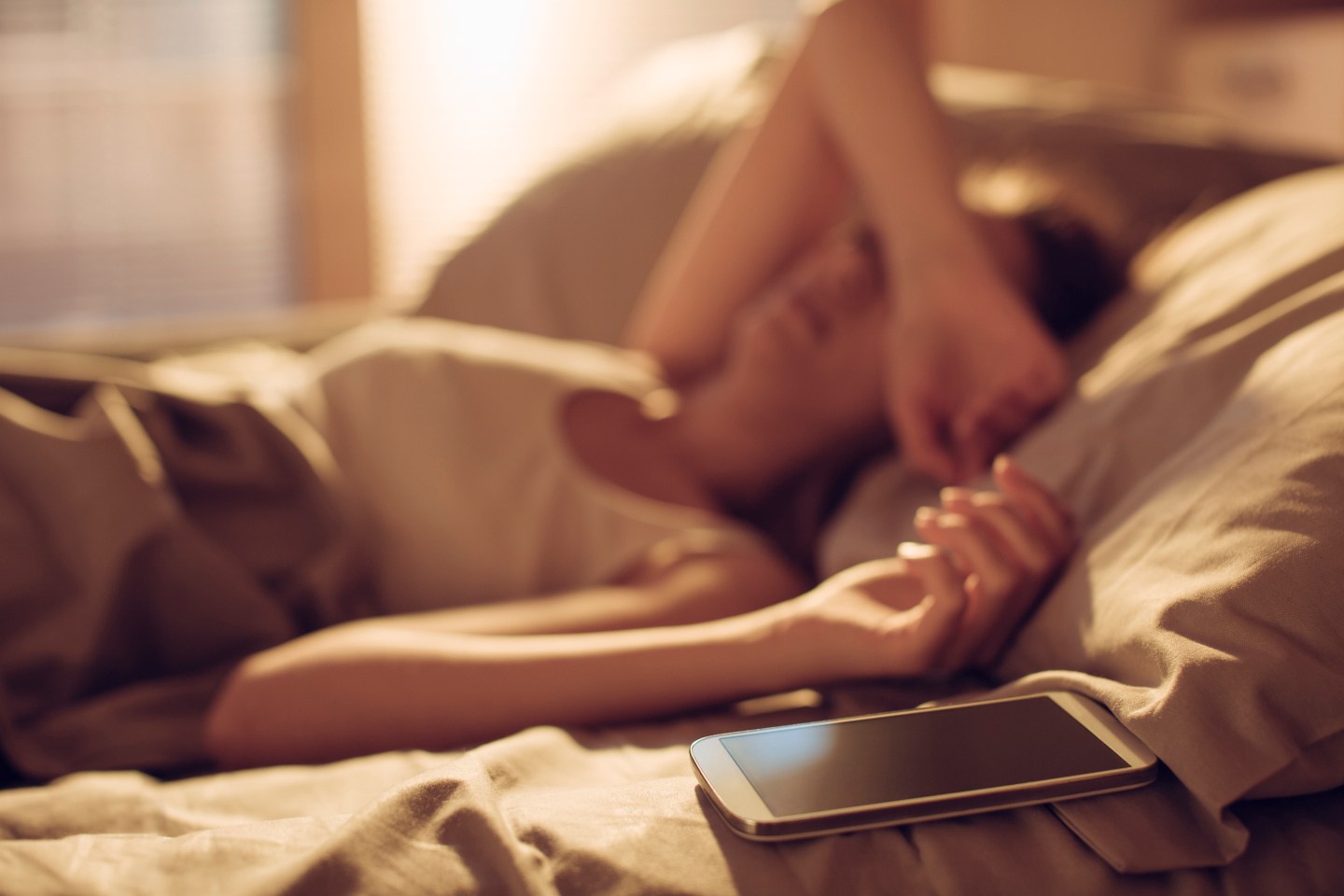 Woman alseep next to smart phone
