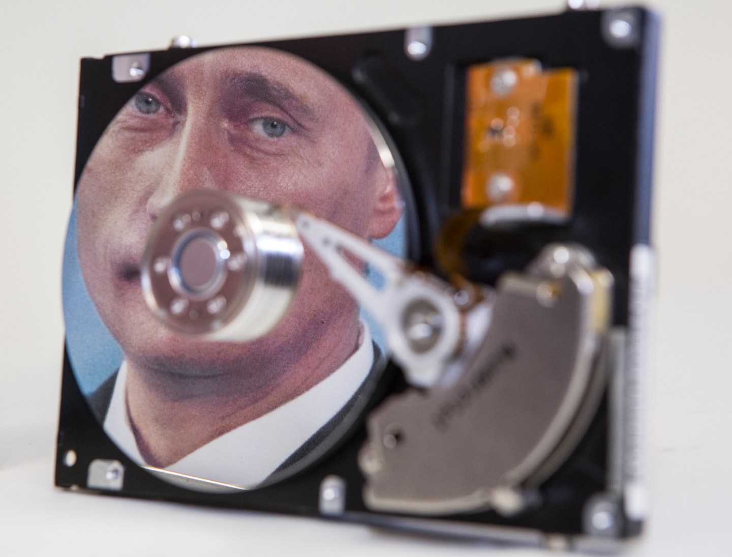 Putin-portrait reflected in a computer hard-drive.