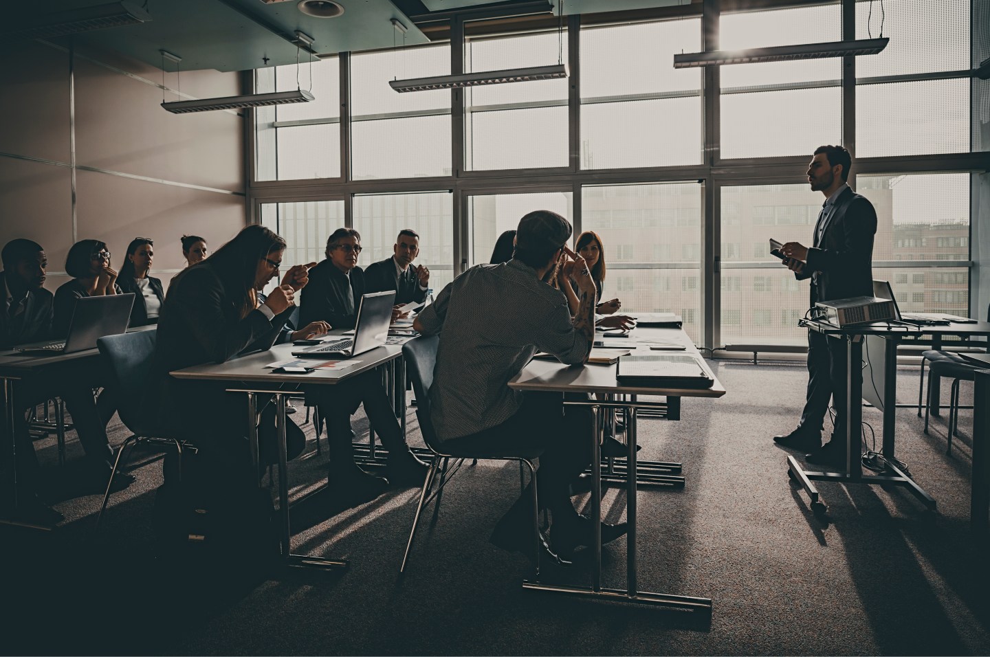 Businesspeople listening to presentation in office building