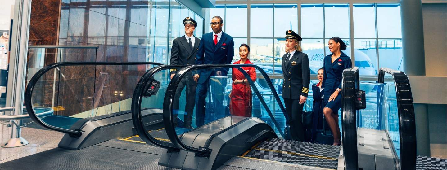 Pilots and Flight Attendants ascending up the escalators. - These images are protected by copyright. Delta has acquired permission from the copyright owner to the use the images for specified purposes and in some cases for a limited time. If you have been authorized by Delta to do so, you may use these images to promote Delta, but only as part of Delta-approved marketing and advertising. Further distribution (including proving these images to third parties), reproduction, display, or other use is strictly prohibited.