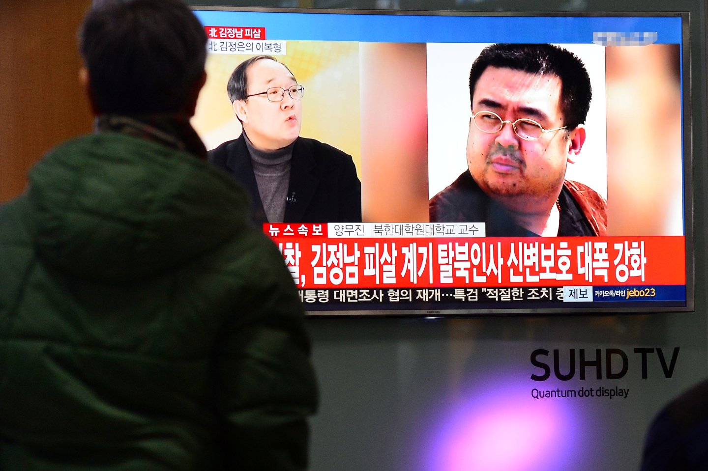 People watch a TV screen broadcasting a news report on the assassination of Kim Jong Nam, the older half brother of the North Korean leader Kim Jong Un, at a railway station in Seoul