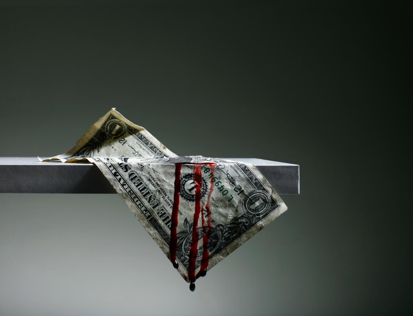 US Dollar hanging from Shelf Bleeding