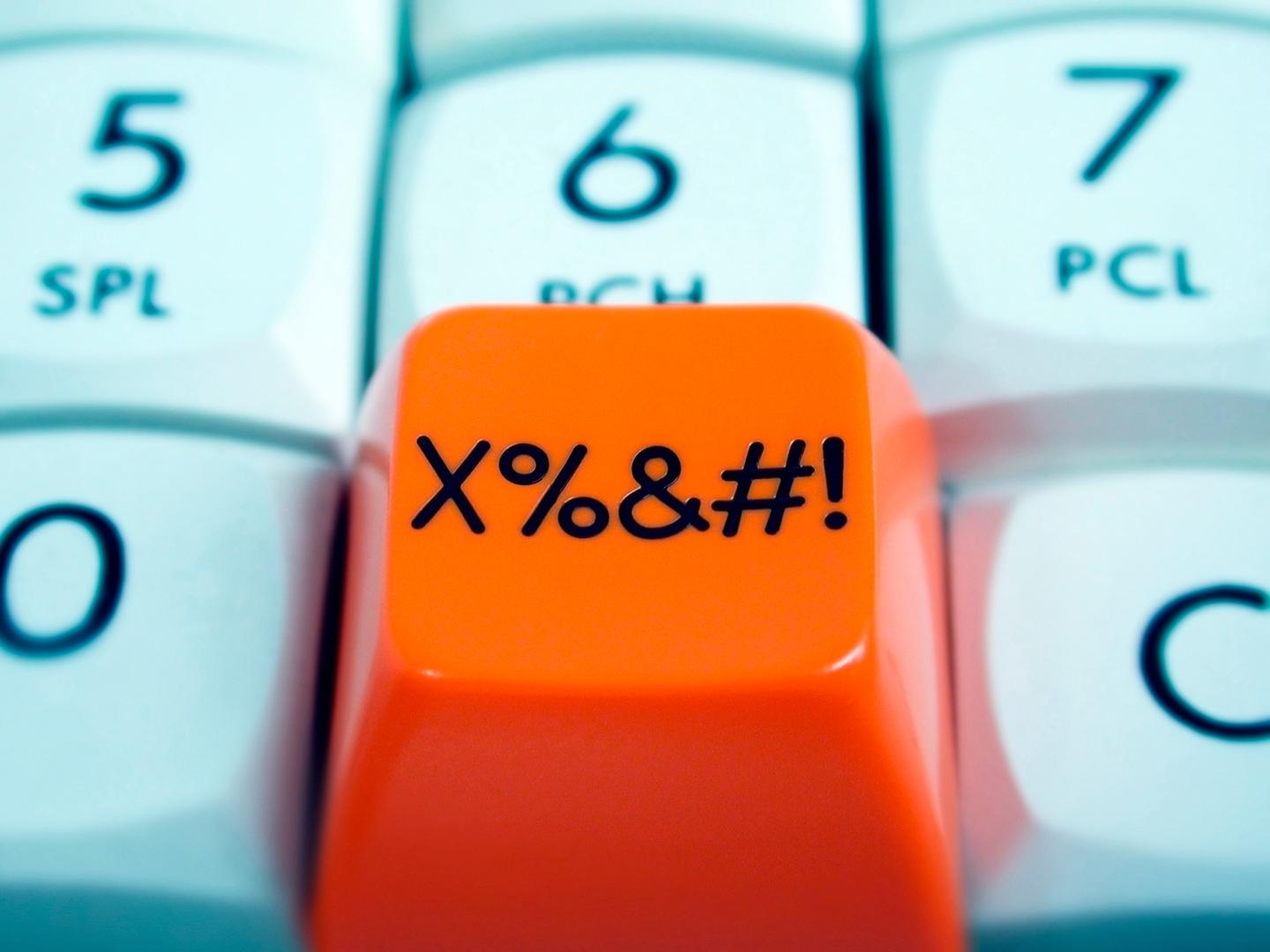 Close up of orange button with symbols