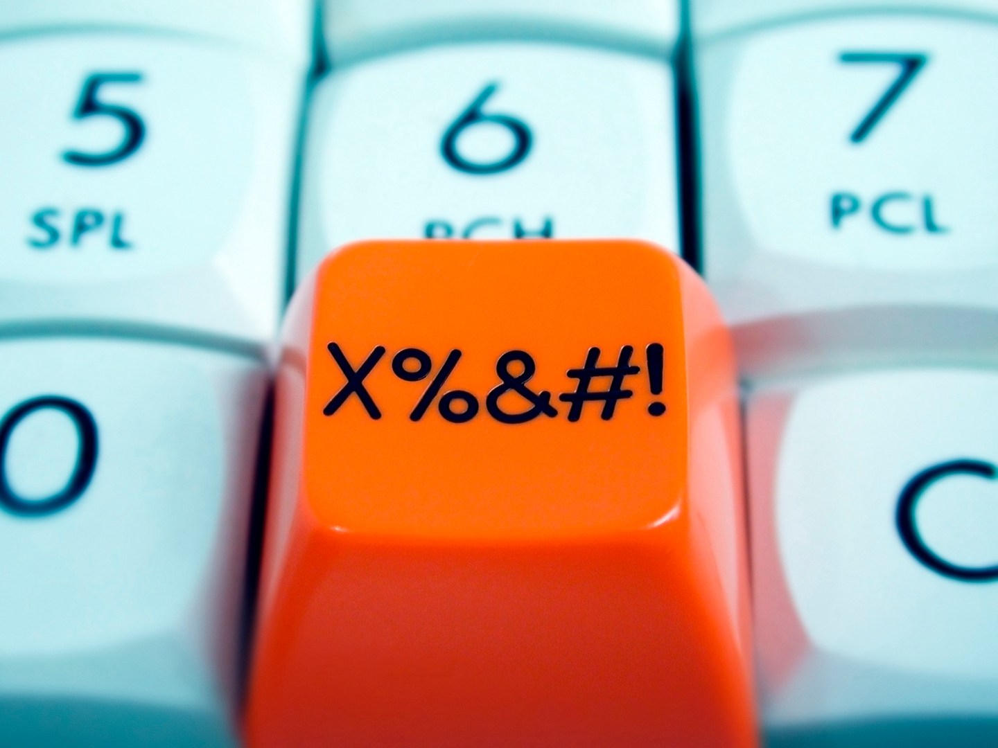 Close up of orange button with symbols