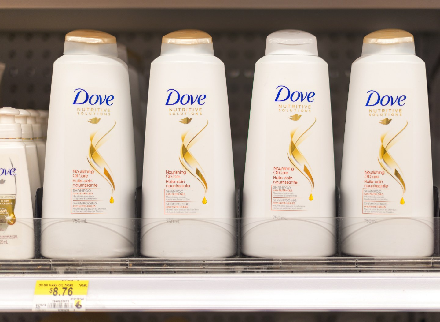 Dove shampoo and conditioner bottles in a shelf. Dove is one