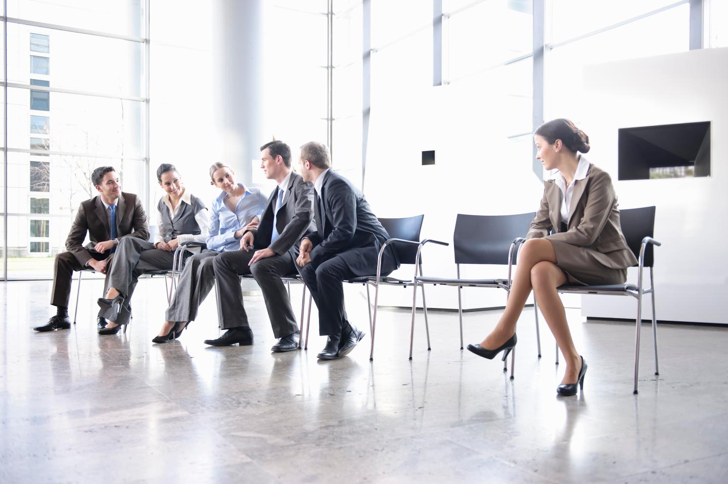Woman sitting alone separate from group