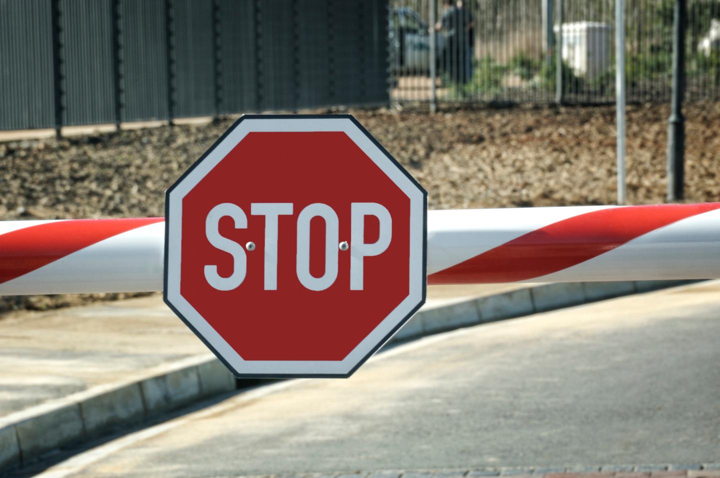 Security entry with big red Stop sign on the beam