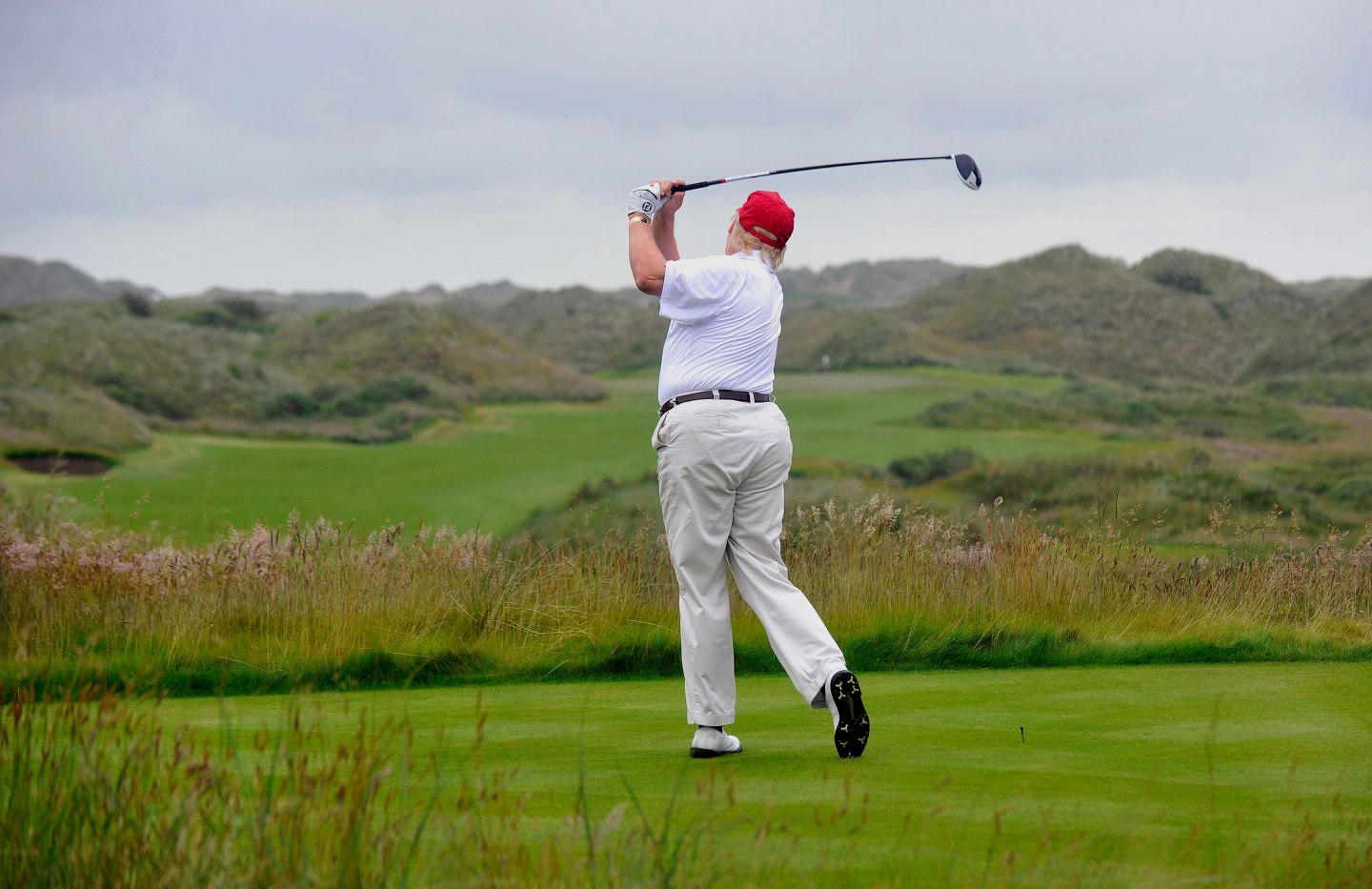 US tycoon Donald Trump plays a stroke as