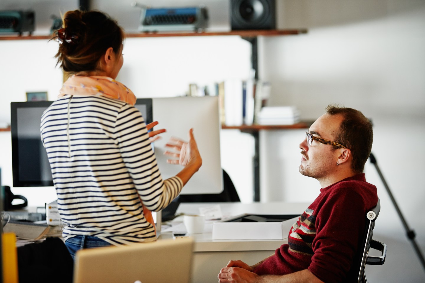 Coworkers discussing project in startup office