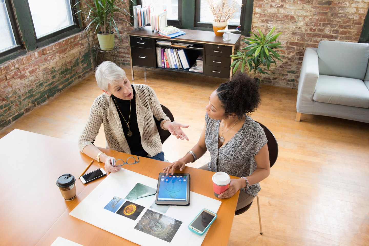 Businesswomen using digital tablet in office